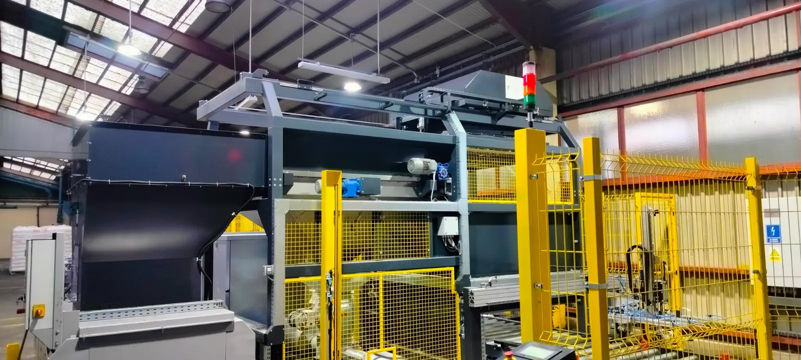 Automated granulate bag depalletizing line integrated with a cardboard layer-picking manipulator-Automateam